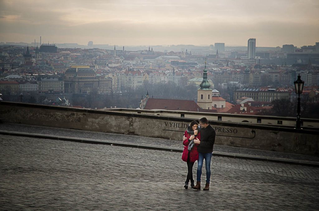 Couple being photographed in Prague Castle, showing Localgraph as a travel gift for couples.