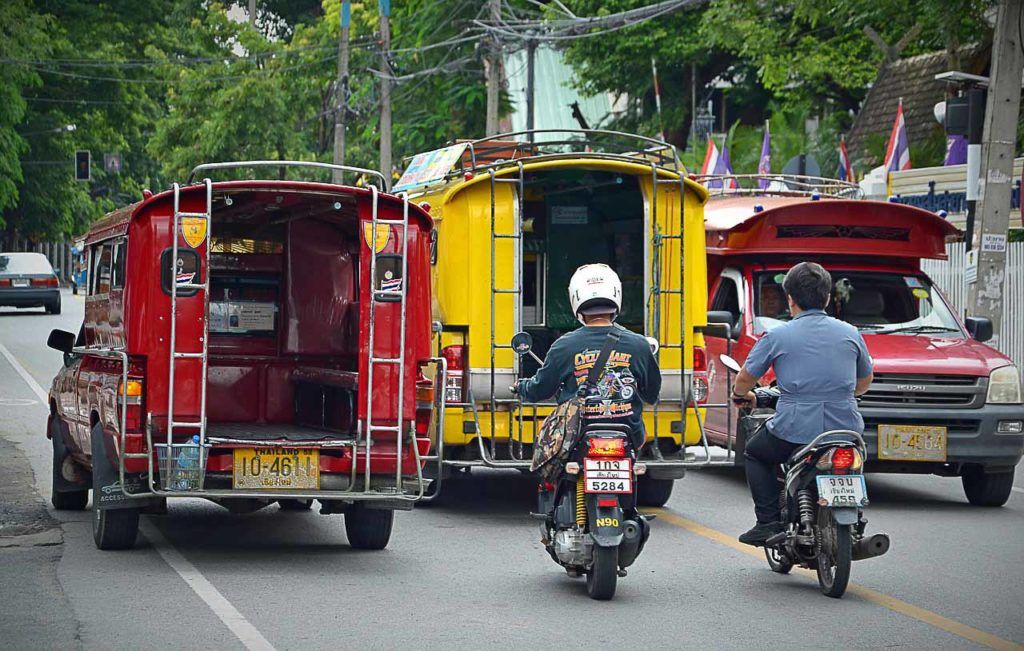Photo of two songthaews, the Thai buses that run inside cities, or between villages.