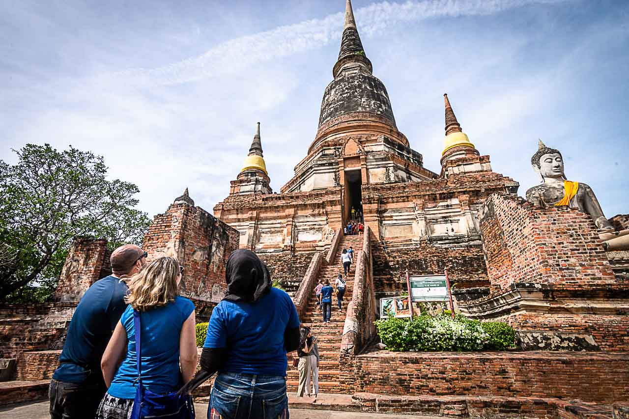 Travelers looking at one of the temples in Ayutthaya Historical Park.