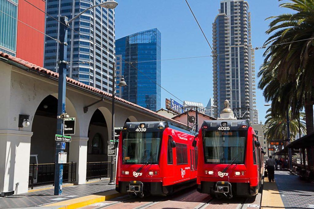 Two red trolleys at the station in San Diego, California, USA. Discover all the costs of traveling to San Diego, California in this complete travel budget article . Prices of food, transport, accommodation and more.